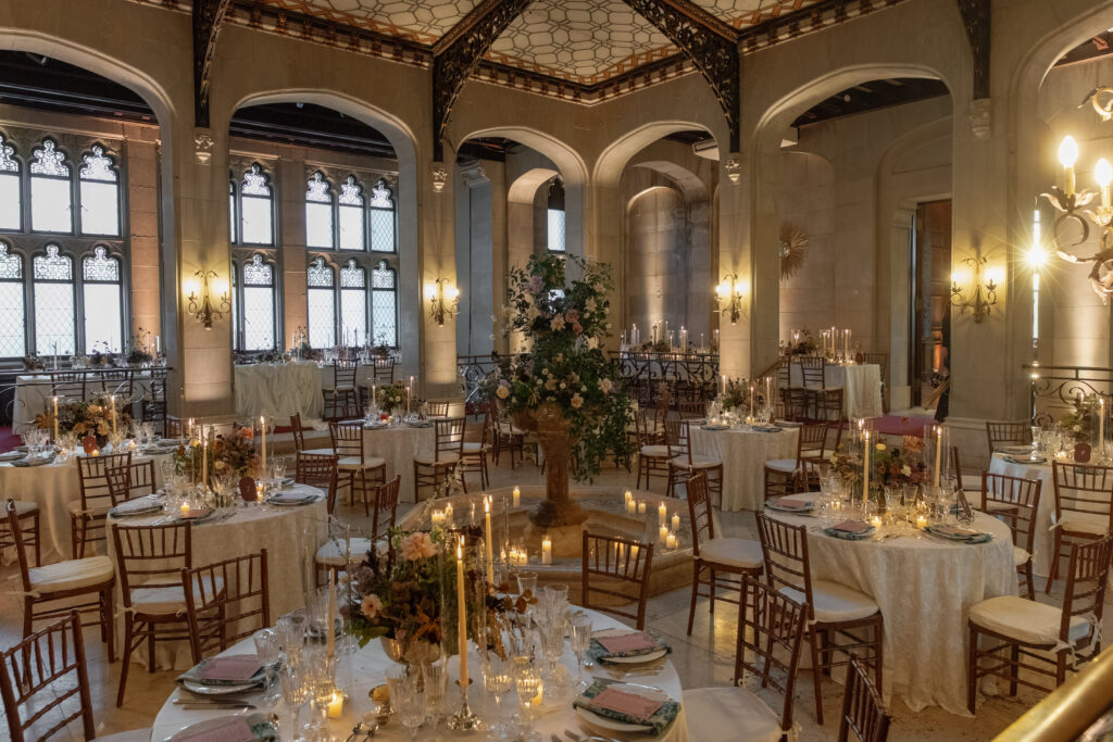 Candlelit wedding reception inside historic Hempstead House in Sands Point