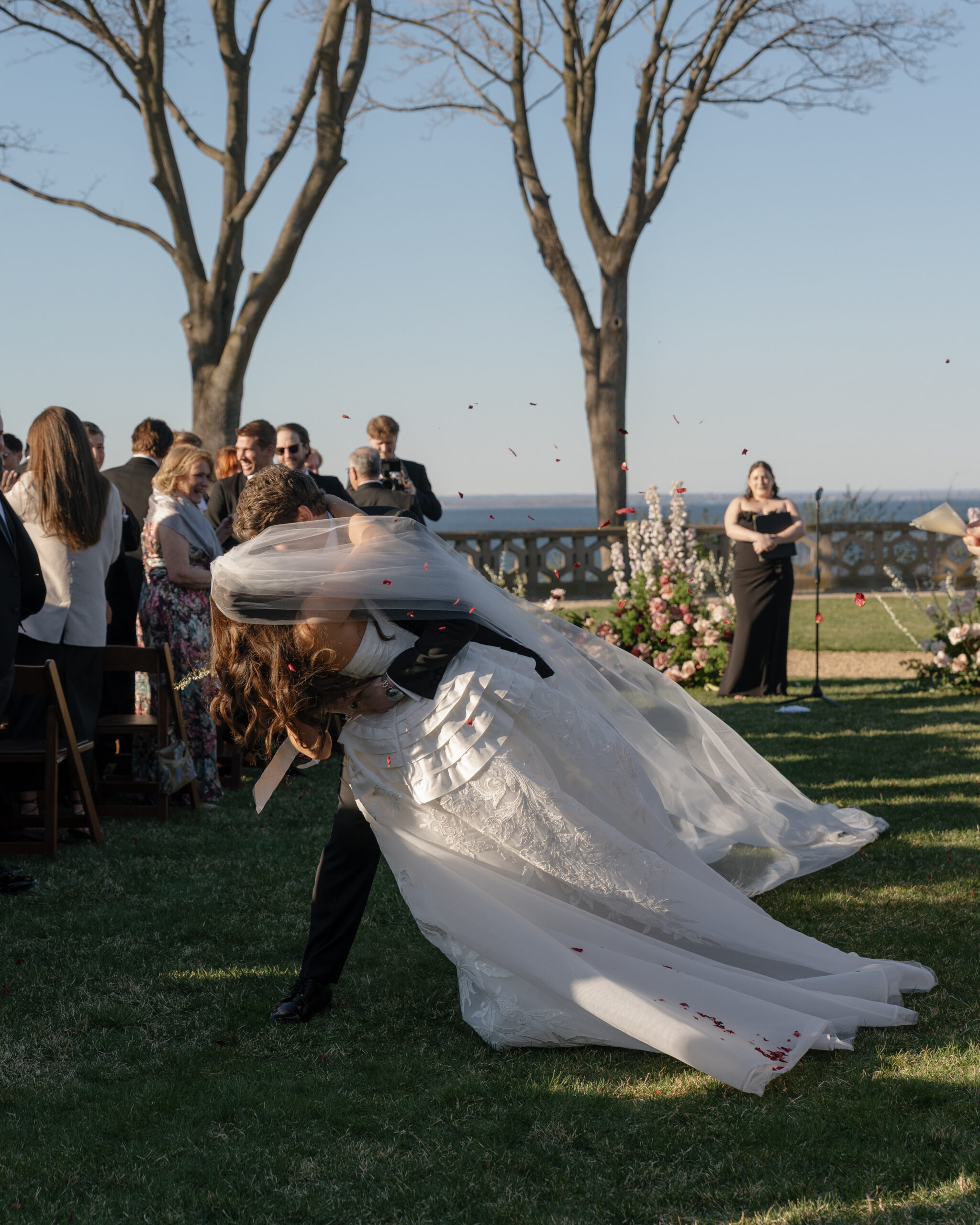 Bride and groom kissing during an outdoor Hempstead House wedding ceremony
